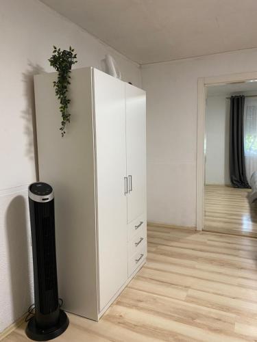 a white cabinet with a plant on it in a room at Kuca za odmor-Tisa Hideaway in Turija