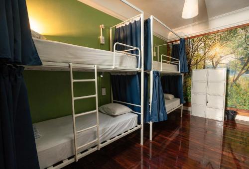 a room with three bunk beds in it at Urban Garden Hostel in Lisbon