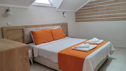 a bedroom with a bed with two towels on it at Tayfun Apart Hotel in Oludeniz