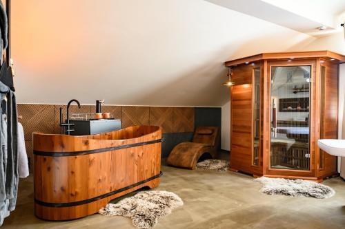 a bathroom with a wooden tub and a sink at Maravar - Beer Spa - Adults Only in Liptovský Trnovec