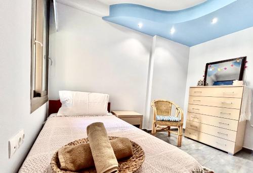 a small bedroom with a bed and a dresser at elva creta beach in Palaiokastro