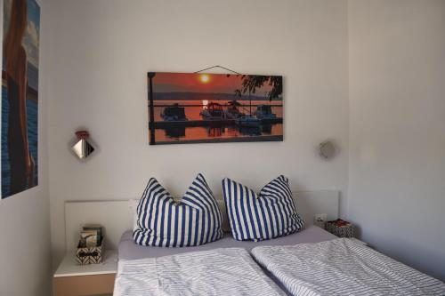 a bedroom with a bed with striped pillows on it at Matteo in Malinska