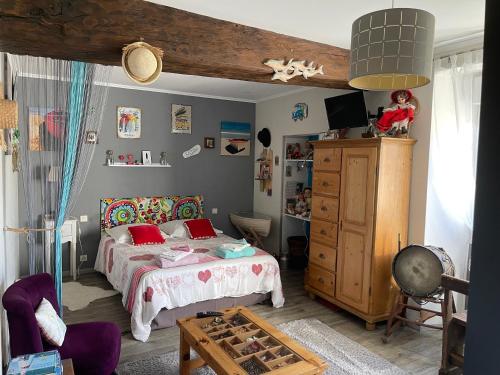 a bedroom with a bed with red pillows on it at Au repos du Lezard in Durtal