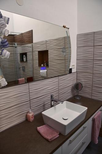 a bathroom with a white sink and a mirror at Matteo in Malinska
