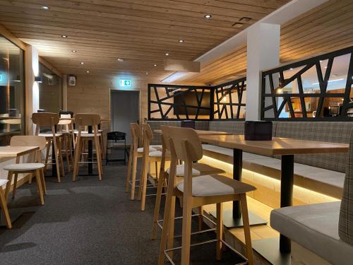 a restaurant with tables and chairs in a room at Chalet Sepp in Belalp