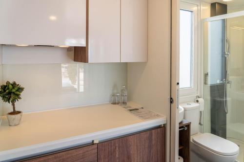 a bathroom with a sink and a toilet at Barbara Piran Beach Hotel in Piran