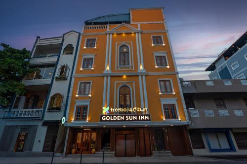 an orange building with a sign on it at Treebo Golden Sun Inn, 5 Mins To Rock Beach in Pondicherry