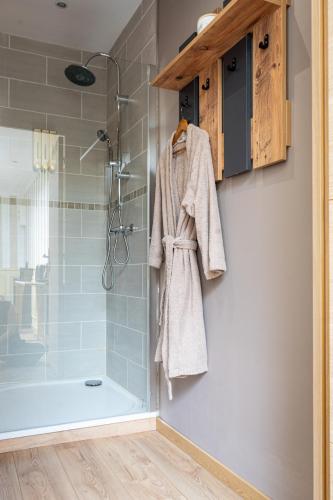 a bathroom with a shower and a towel hanging on a wall at La suite Isabelle de Luxembourg in Béthune