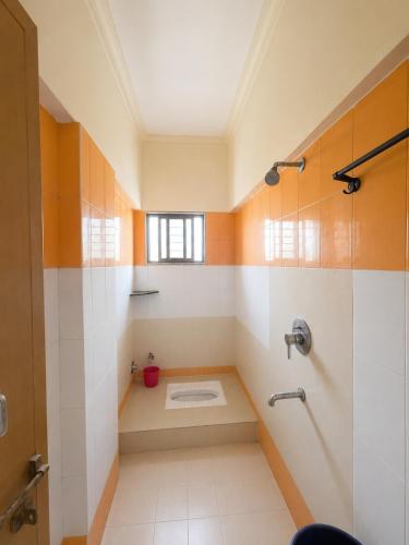 a bathroom with a shower and a toilet in it at Hotel Shree Jay Amba Deluxe in Jaisingpur