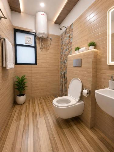 a bathroom with a toilet and a sink at Hotel ONBellamount Comfort Villa Delhi Airport - Free Airport PickUp & Drop in New Delhi