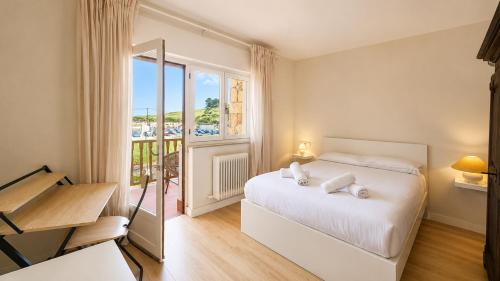 a bedroom with a bed and a large window at Villa Toro Playa Llanes a 100 m de la playa in Llanes