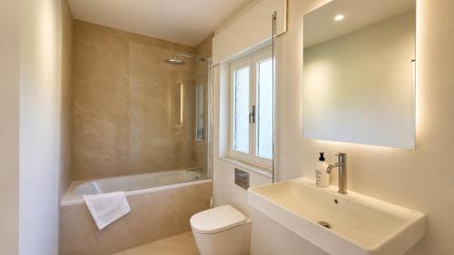 a bathroom with a sink and a toilet and a shower at Villa Toro Playa Llanes a 100 m de la playa in Llanes