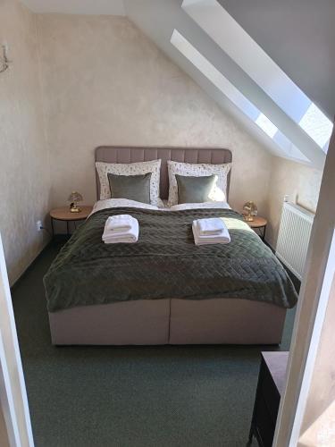 a bedroom with a large bed with two tables at Boutique Hotel Empress in Rožňava