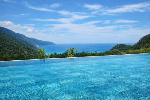 a swimming pool with a view of the ocean at Ölüdeniz Manzara Non Alcoholic Family Hotel in Oludeniz