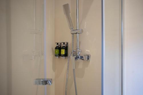 a glass shower door with three bottles of wine at Quinta la Sal by SingularStays in Jávea