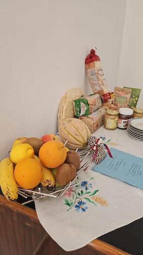 a plate of fruit and vegetables on a table at B&B Le Fontane in Bono