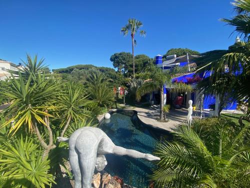 a statue of a man playing in a swimming pool at Villa Karolina in Quarteira