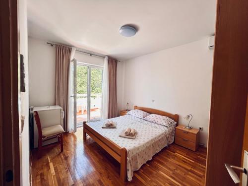 a bedroom with a bed with a table and a window at room MLIN 1 in Lun