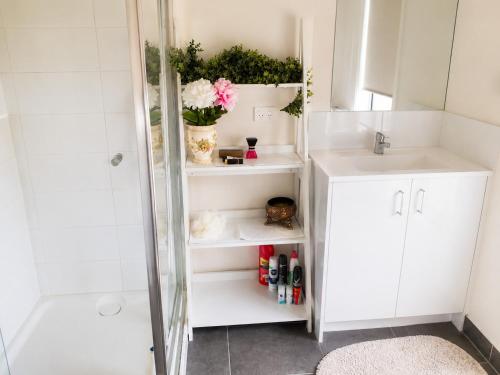 a bathroom with a sink and a shower at Room in Officer in Officer