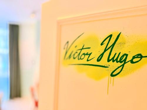 a sign on the side of a building with the words visitor adviser at Hotel La Petite Rosa in Paris