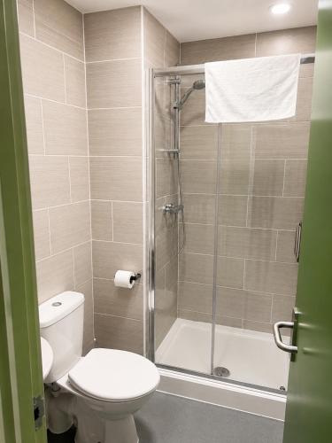 a bathroom with a toilet and a shower at Liberal House Tamworth in Tamworth
