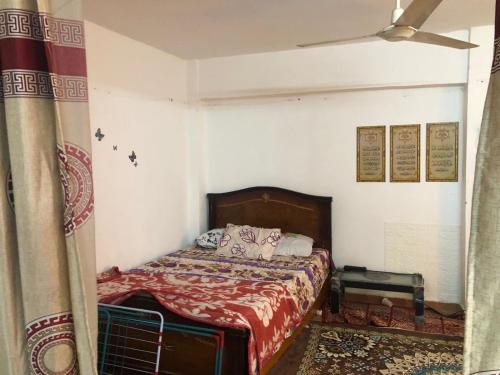 a bedroom with a bed with a red blanket at مقاولين العرب in Cairo