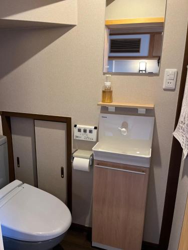 a small bathroom with a toilet and a sink at 雅 in Kyoto
