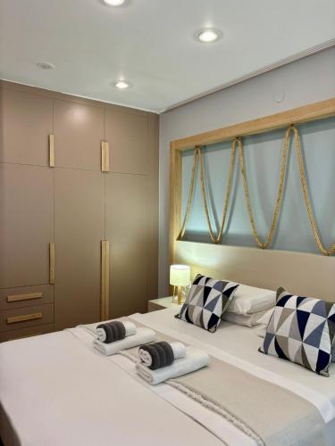 a bedroom with two large beds with pillows at Green Suite Skiathos in Skiathos