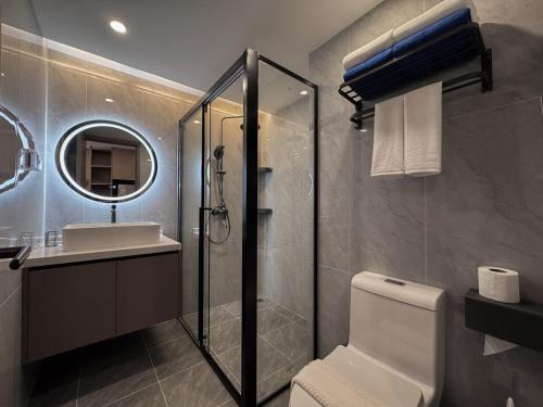 a bathroom with a shower and a toilet and a sink at Stylish Pool View 1BDR Apartment Bang Tao in Ban Thalat Choeng Thale
