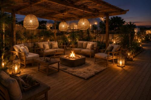 a patio with couches and a fire pit with lights at Buba Glamp - Hotel Burbuja in Blascoeles