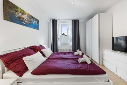 a bedroom with a bed with a teddy bear on it at City Residence - Sankt Pölten in Sankt Pölten