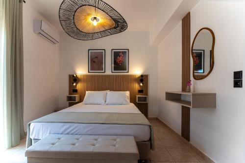 a hotel room with a bed and a mirror at Gallery Home in Kardamaina