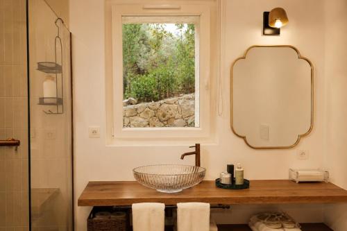 a bathroom with a sink and a mirror and a window at Le Mas des Chènes in Taradeau