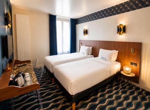 a hotel room with two beds and a television at Kyriad Hotel XIII Italie Gobelins in Paris