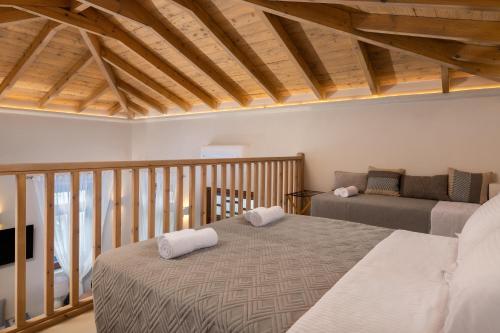 a bedroom with a bed and a couch at Archontiko Residence in Koskinou