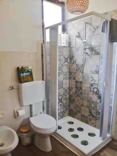a bathroom with a shower and a toilet at RaMaya casa d'artista 2 in Biella