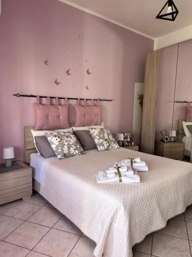 a bedroom with a large bed with towels on it at Butterfly House in Villaputzu