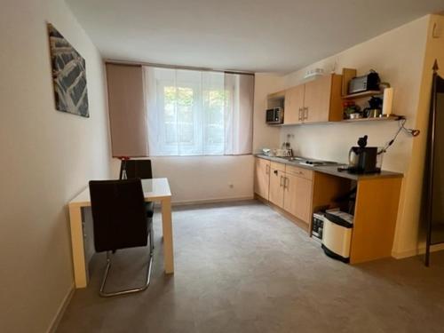 a kitchen with a desk and a table in a room at Conny's Ferienwohnung in Bietigheim-Bissingen