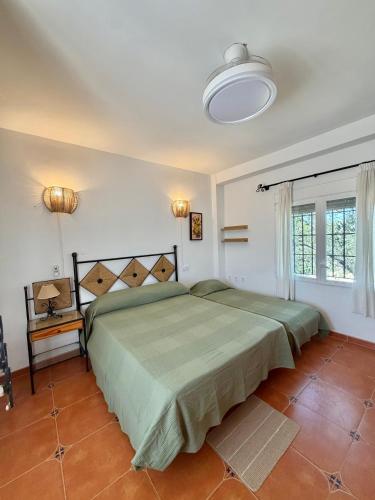 a bedroom with a large bed in a room at Finca Jaralta de Carmen in La Puebla de los Infantes