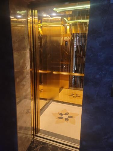 a glass shower with a flower on the floor at Moveck Inn in Dar es Salaam