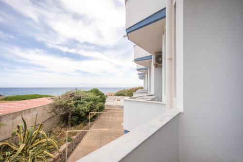 a balcony with a view of the ocean at Hotiday Castelsardo Spiaggia in Castelsardo