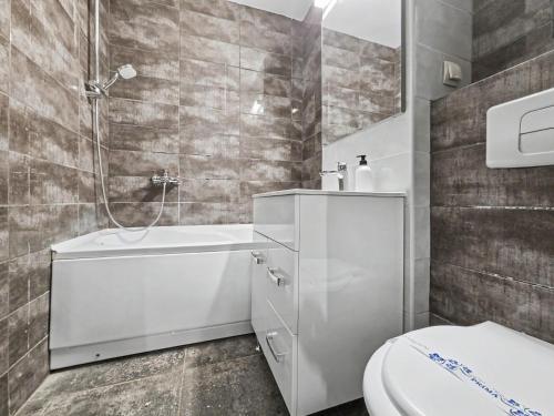 a bathroom with a white tub and a toilet at Konstanzer Stefan 15 - Old Town Apt - Palas Mall - AC in Iaşi
