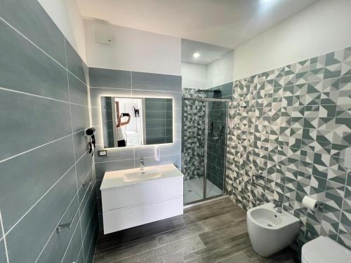 a bathroom with a sink and a toilet and a shower at Blue Cave b&b in Palinuro