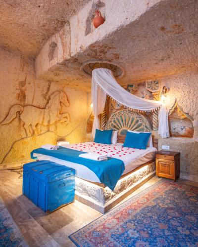 a bedroom with a bed in a stone room at Bayar Cave Suites Special Class in Ürgüp