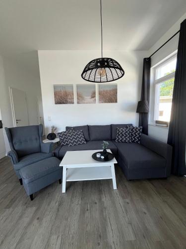 a living room with a couch and a table at Villa Marin, Wohnung 17 in Zinnowitz