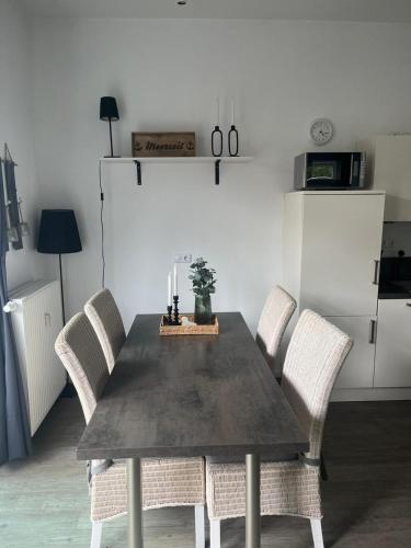 a dining room with a table and chairs with candles at Villa Marin, Wohnung 17 in Zinnowitz