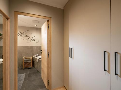 a bathroom with white cabinets and a sink at Appartement Krismer in Fügen