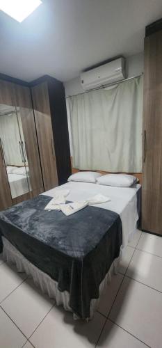 a bedroom with a large bed in a room at Casa confortável para o são joão in Campina Grande