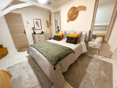 a bedroom with a large bed with yellow and green pillows at Domaine VALENQUERCY in Cazillac
