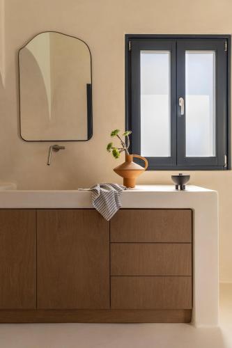 a bathroom with a sink and a mirror at Exomitis1 Cellar & Sea Escape in Agios Georgios Thalassiti